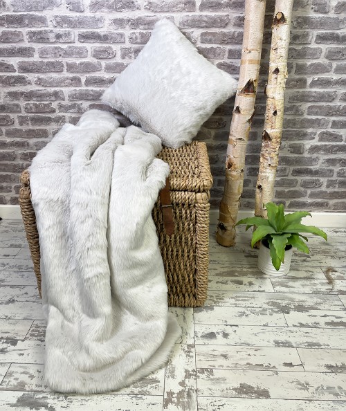 Silver white faux fur blanket with fur cushion