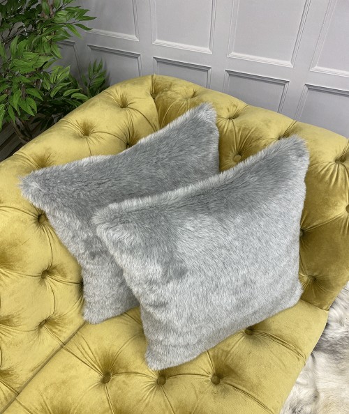 Light grey faux fur cushions