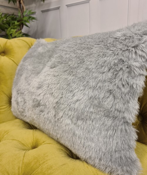 Pale grey rectangular fur cushions